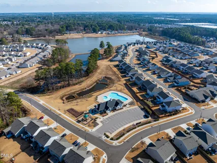 an aerial view of a house with outdoor space and lake view