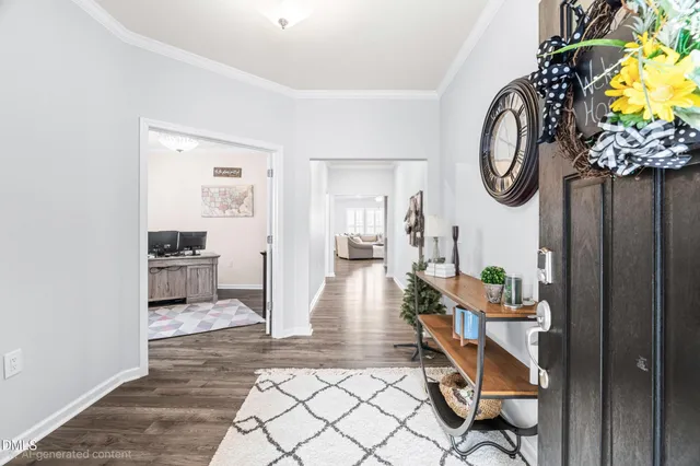 a view of a house with a small yard and potted plants
