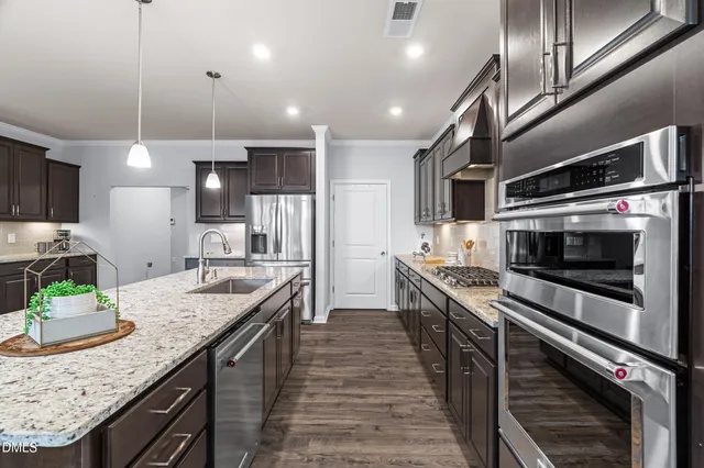 a kitchen with stainless steel appliances a refrigerator sink and stove