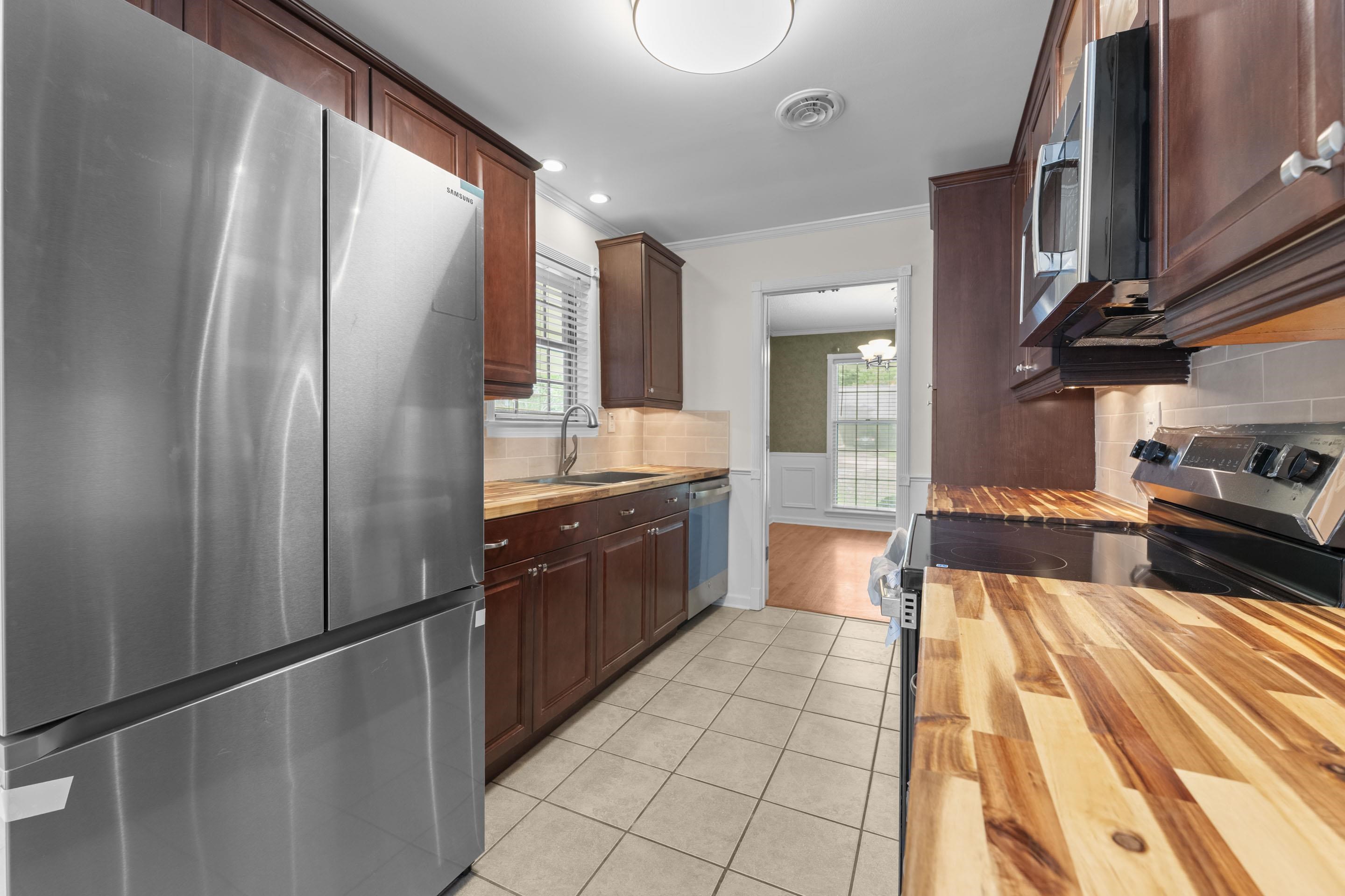 499 Duscoe Street Collierville, TN 38017 - Photo 5 of 38 a large kitchen with stainless steel appliances granite countertop a refrigerator and a sink