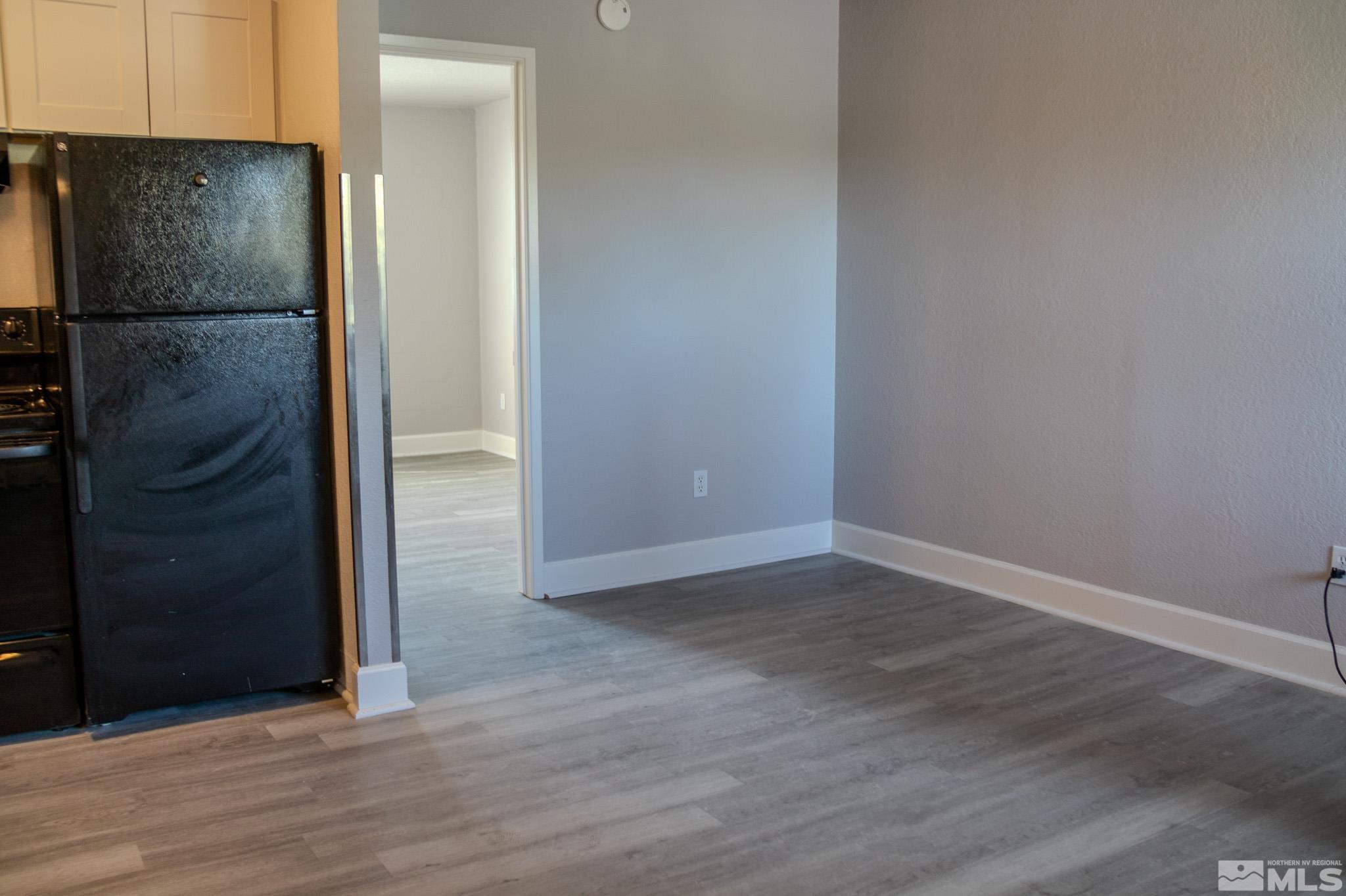 175 East Grove Street, Unit 30 Reno, NV 89502 - Photo 2 of 11 an empty room with wooden floor and a sink