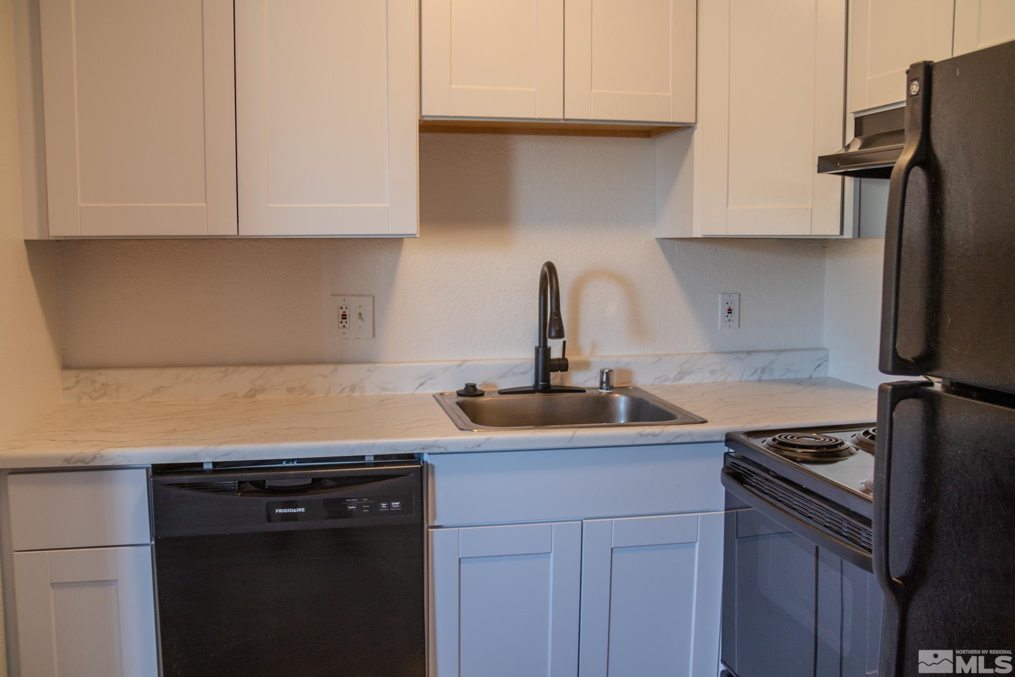 175 East Grove Street, Unit 30 Reno, NV 89502 - Photo 5 of 11 a kitchen with stainless steel appliances granite countertop a sink stove and refrigerator