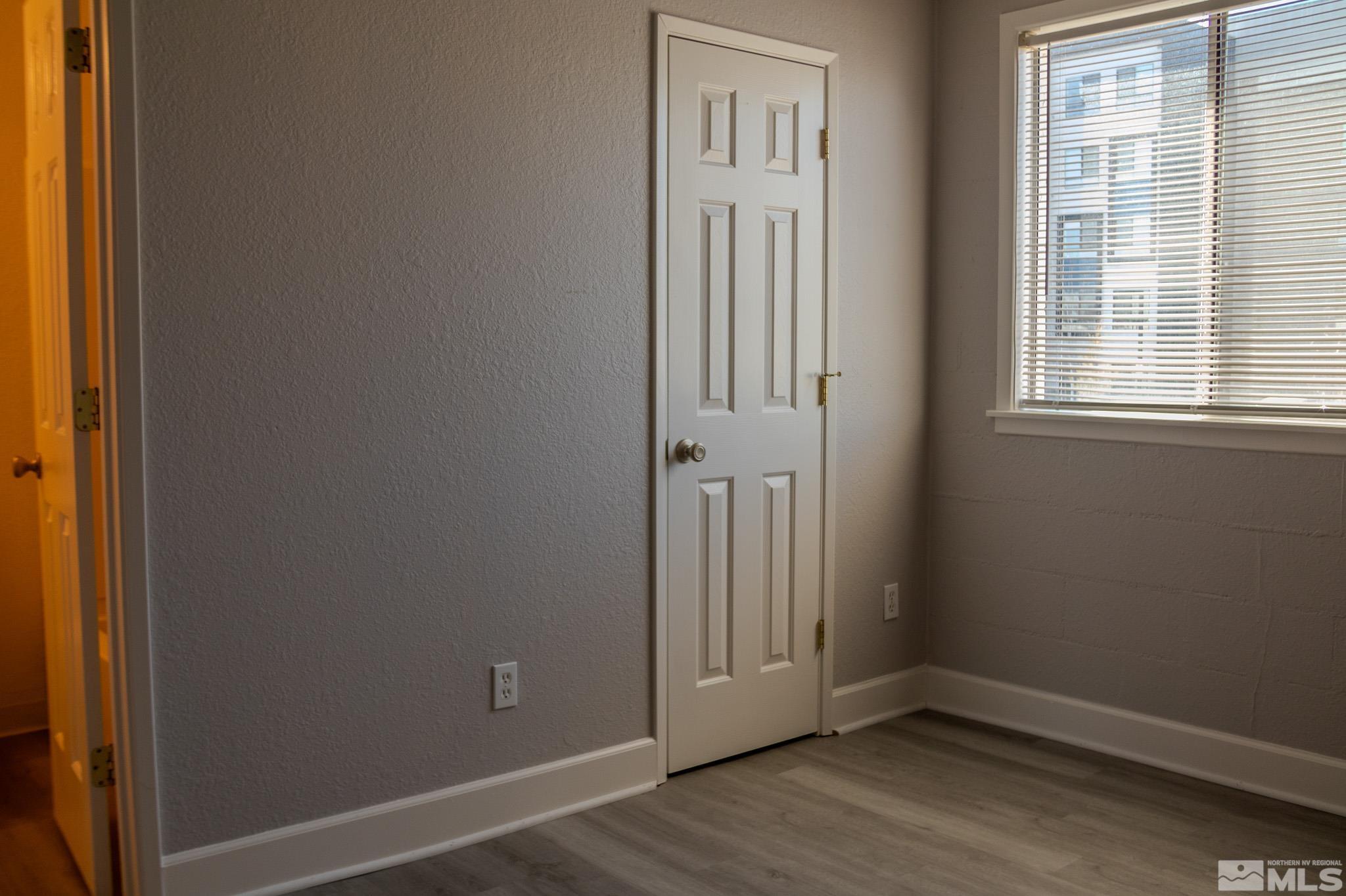 175 East Grove Street, Unit 30 Reno, NV 89502 - Photo 7 of 11 an empty room with wooden floor and a window