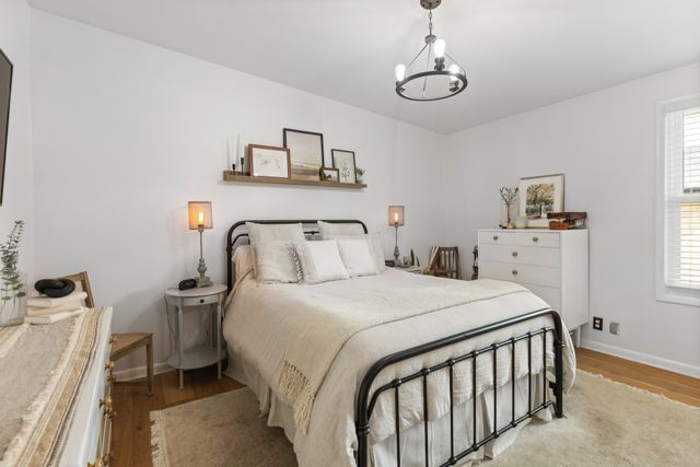 a bedroom with a bed and a chandelier