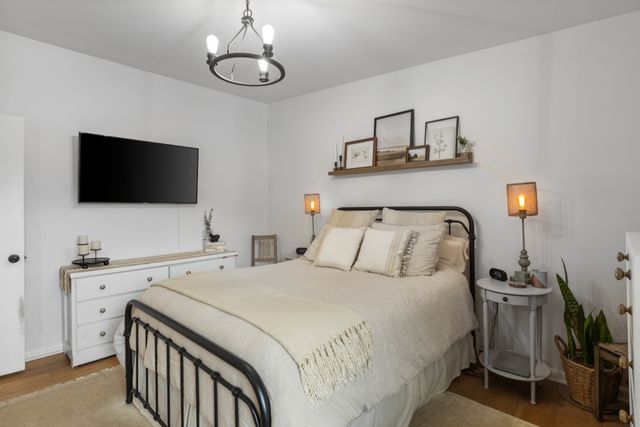 a bedroom with a bed and a flat screen tv