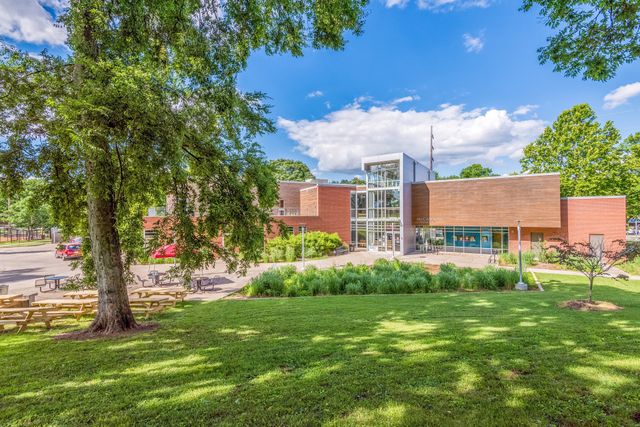 a view of a garden with a building in the background