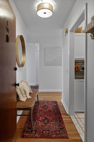 a room with chairs and a rug