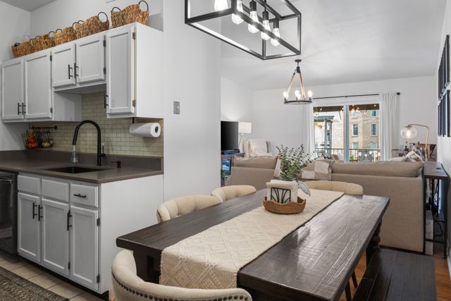 a kitchen with stainless steel appliances a table and chairs