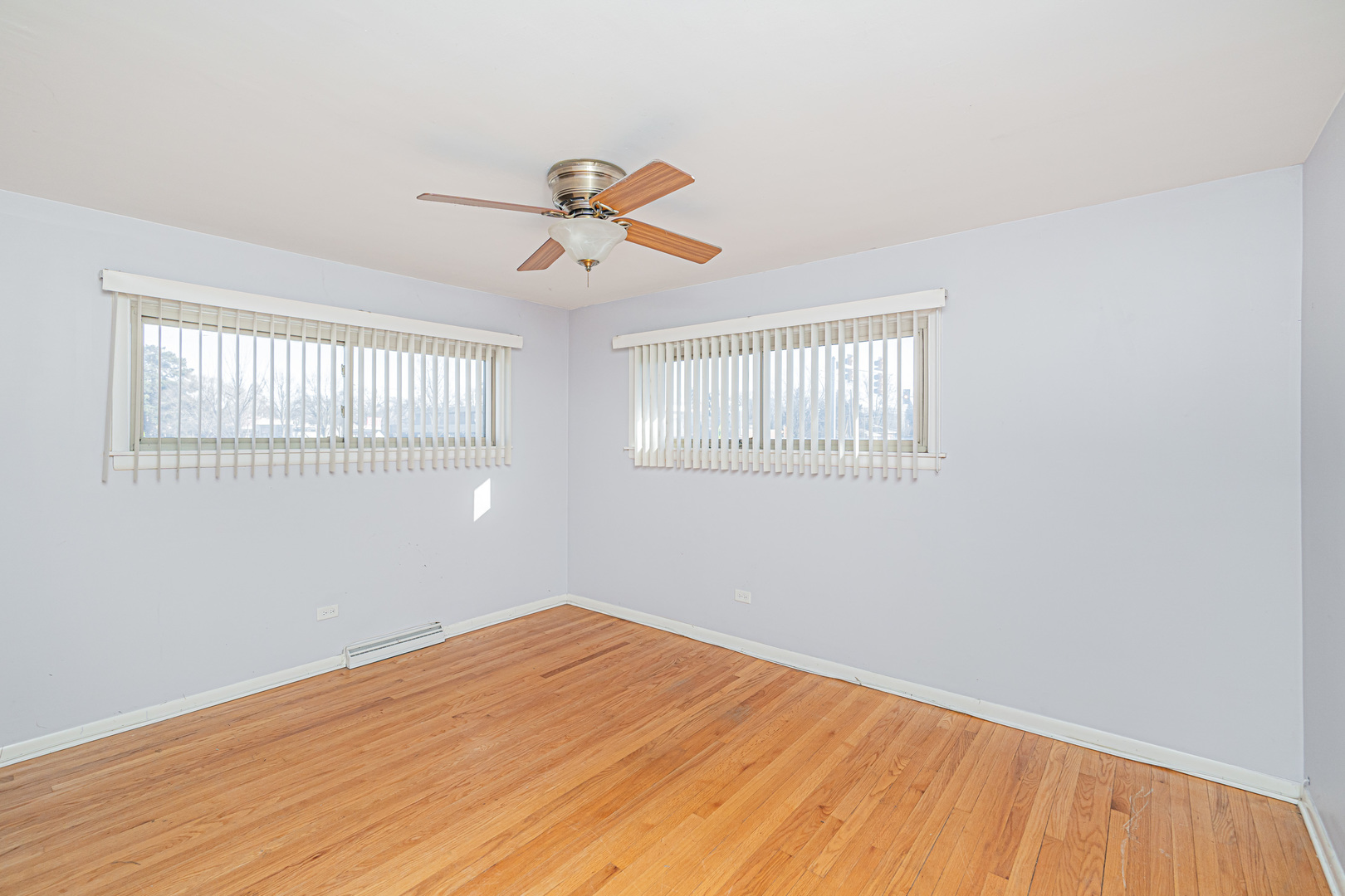 900 Devon Avenue Park Ridge, IL 60068 - Photo 12 of 30 a view of a room with wooden floor and windows