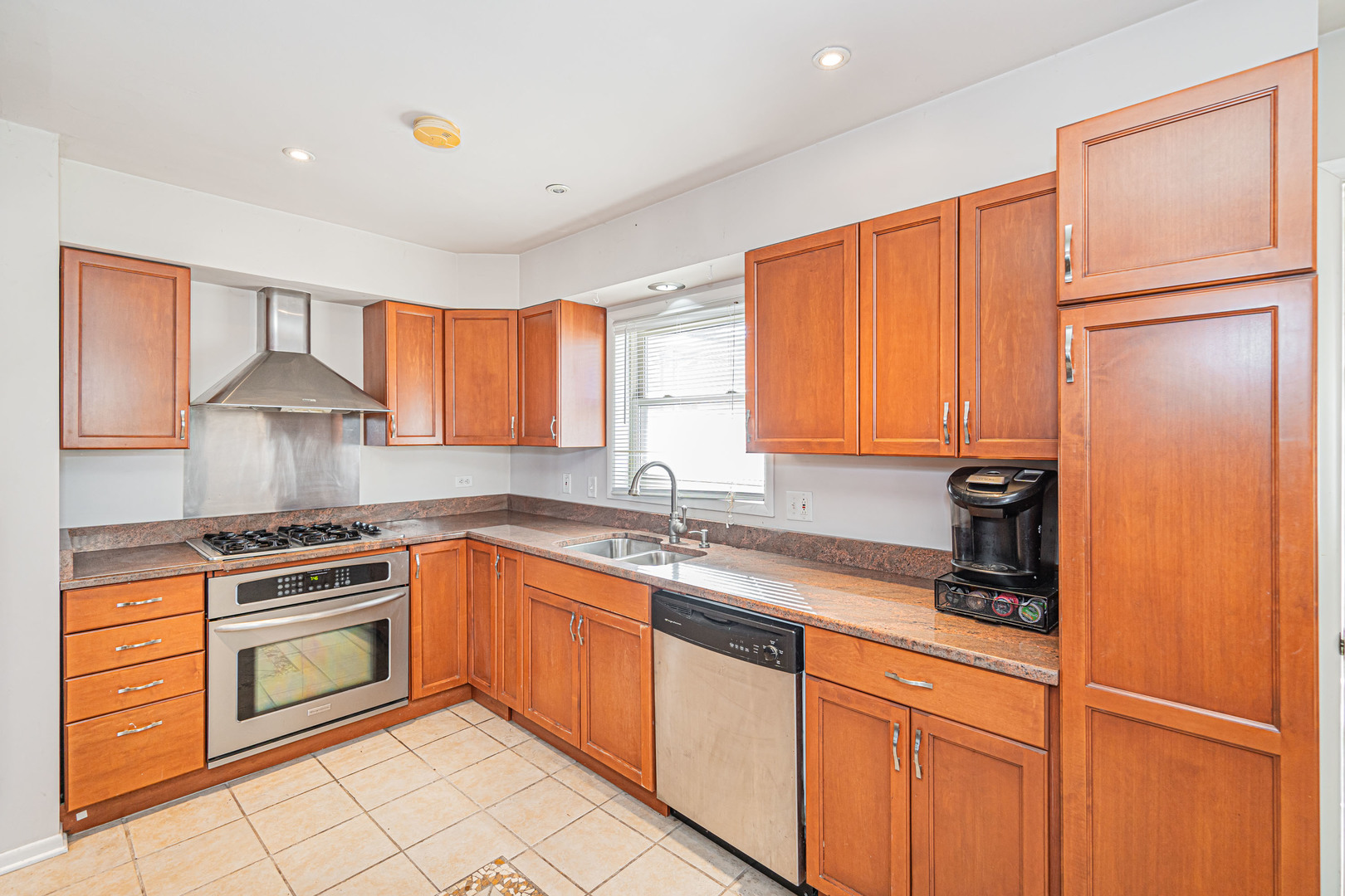 900 Devon Avenue Park Ridge, IL 60068 - Photo 5 of 30 a kitchen with stainless steel appliances granite countertop a sink stove and refrigerator