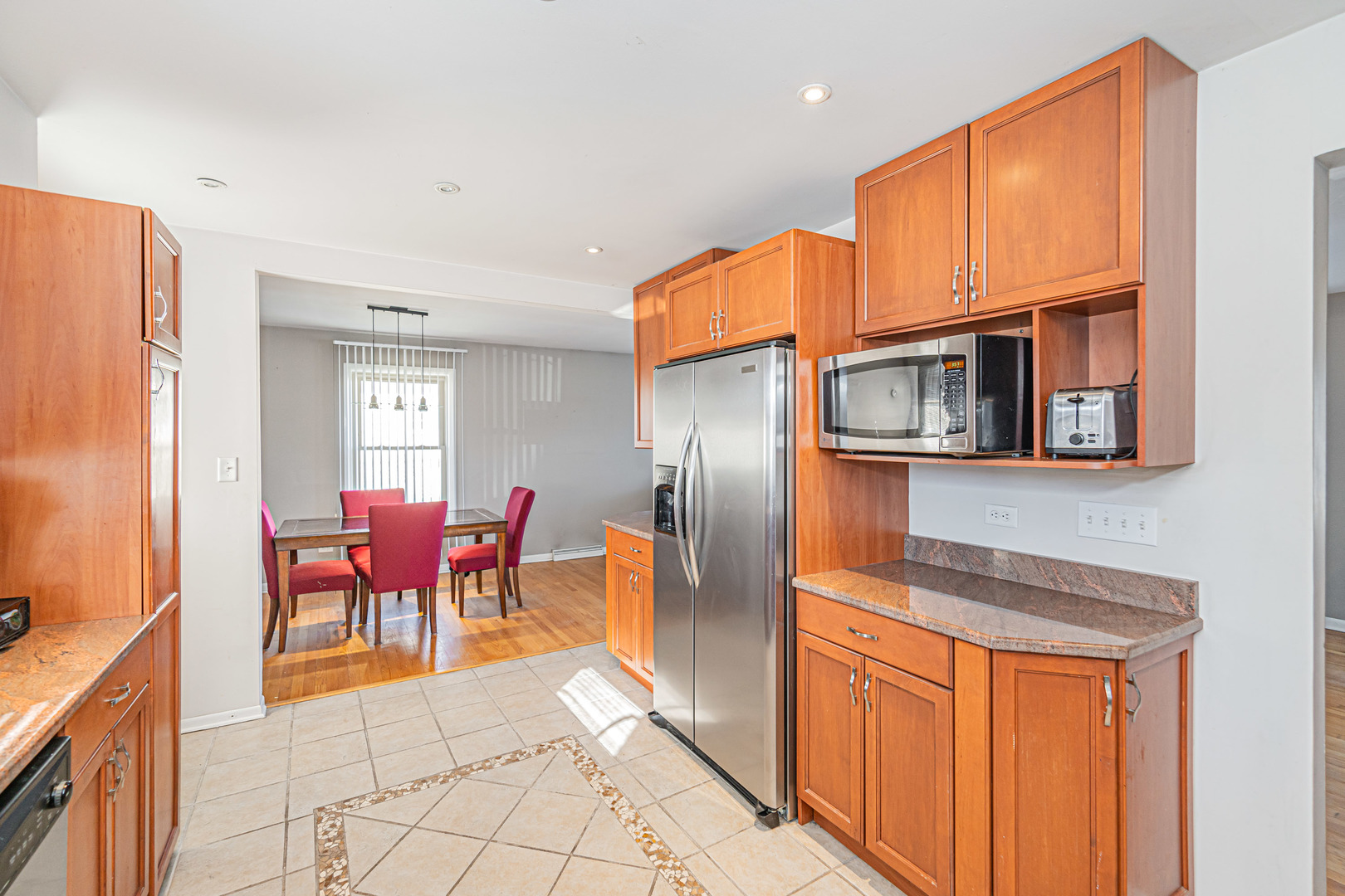 900 Devon Avenue Park Ridge, IL 60068 - Photo 8 of 30 a kitchen with stainless steel appliances granite countertop a refrigerator and microwave