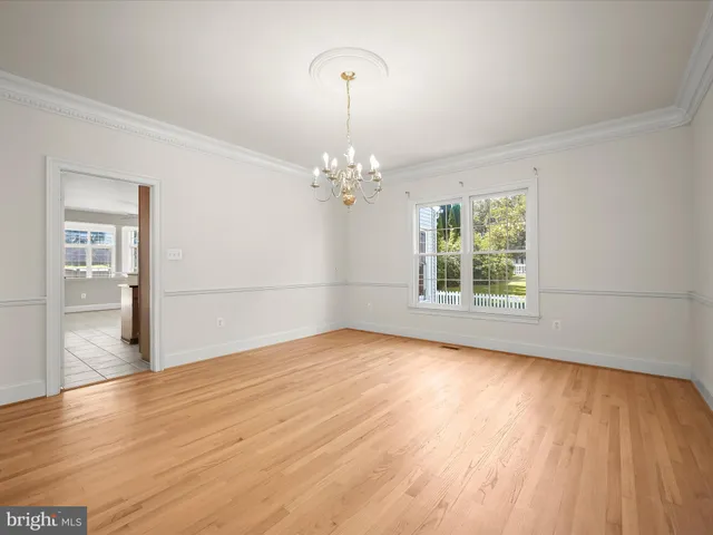 a kitchen with stainless steel appliances granite countertop a stove top oven a sink a counter top space cabinets and a window