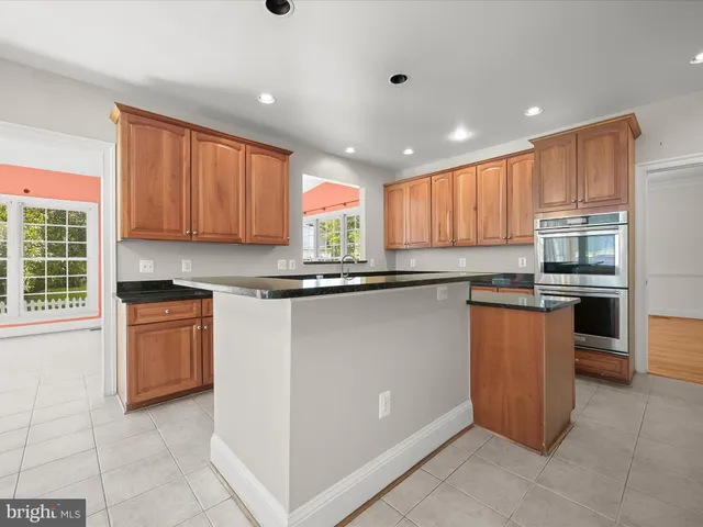 a view of an empty room with a window and fireplace