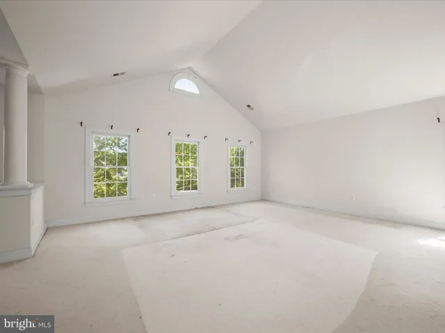 a view of a brick house with a yard and large tree