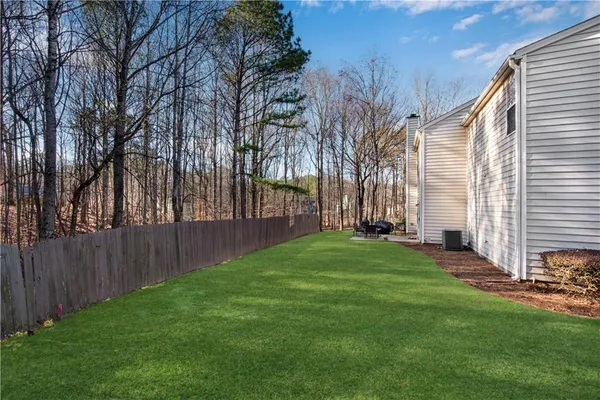 a front view of a house with a garden and yard