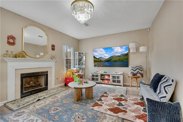 a living room with furniture and a fireplace