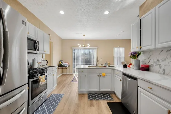 a view of a dining room with furniture and a chandelier