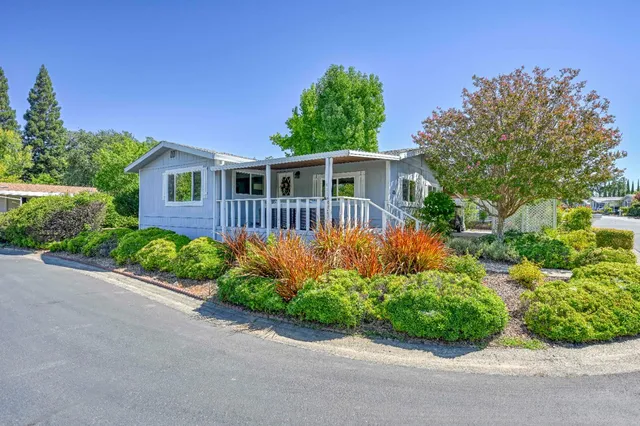 a front view of a house with a garden