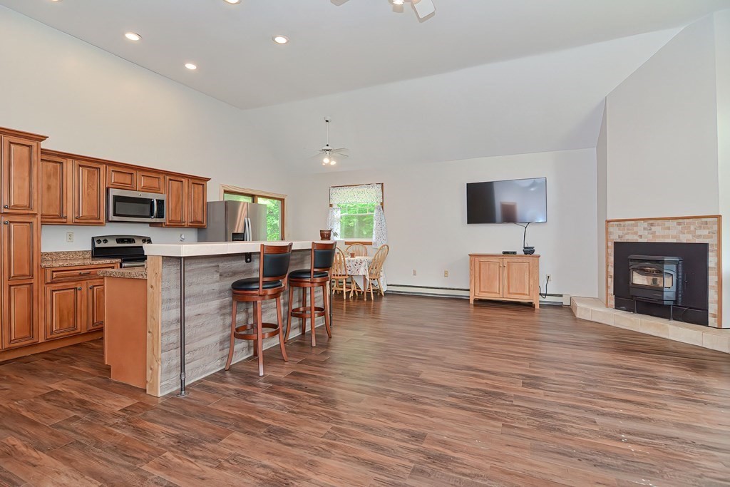5 Salmon Brook Road Brookfield, MA 01506 - Photo 35 of 37 a living room with furniture a fireplace and a flat screen tv