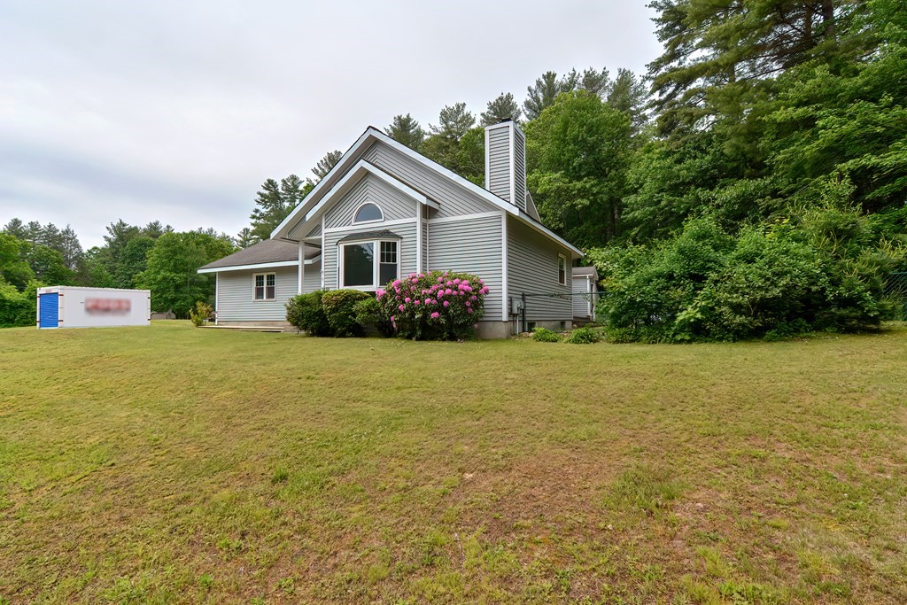 5 Salmon Brook Road Brookfield, MA 01506 - Photo 8 of 37 a front view of house with yard and trees in the background