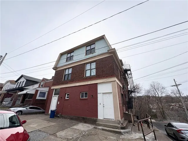 a front view of a house with a parking space