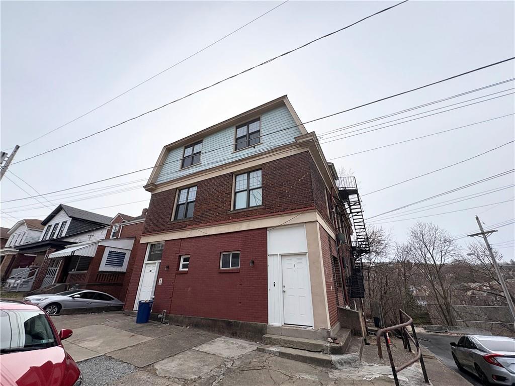 a front view of a house with a parking space