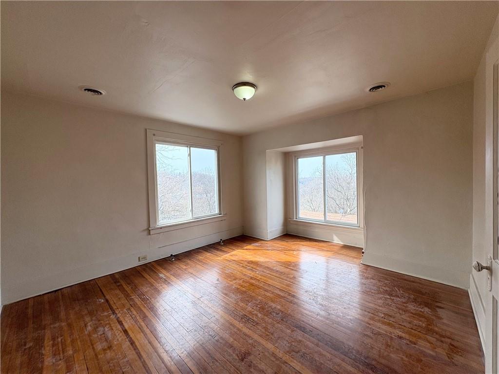 340 Rochelle Street, Unit 4 Pittsburgh, PA 15210 - Photo 3 of 6 a view of an empty room with wooden floor and a window