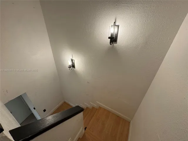 a view of a living room with wooden floor