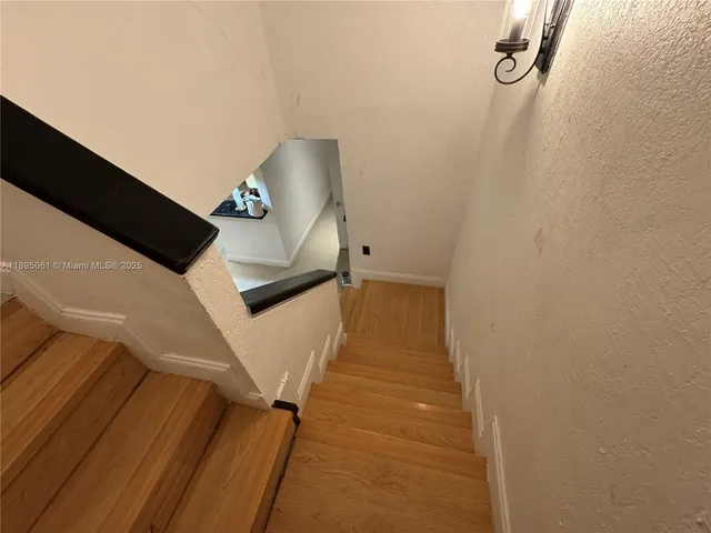 a white toilet sitting next to a shower