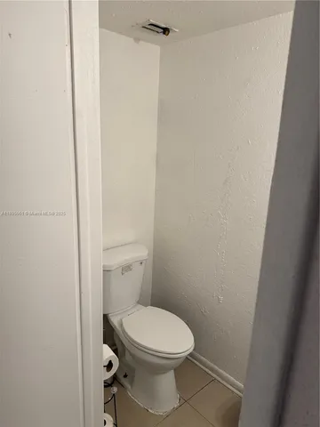 a view of a street with a cars parked and small park