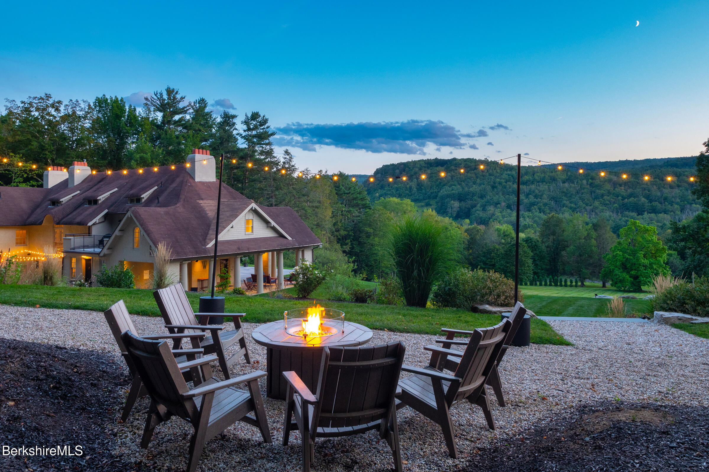 a view of a house with backyard porch and sitting area