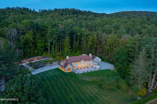 a view of a backyard with a garden and entertaining space