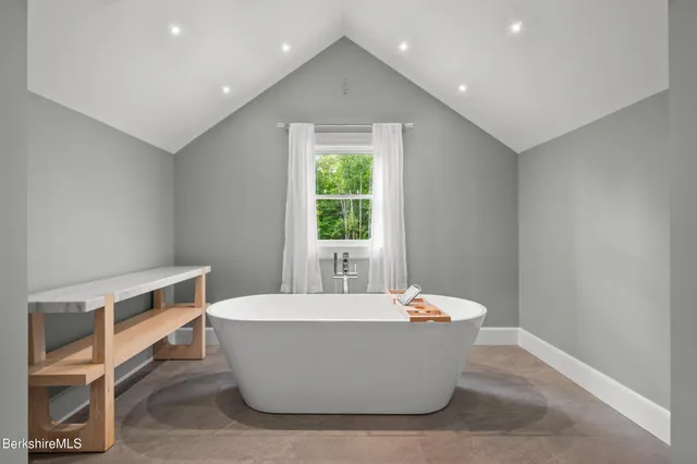 a bedroom with a large bed and a flat screen tv