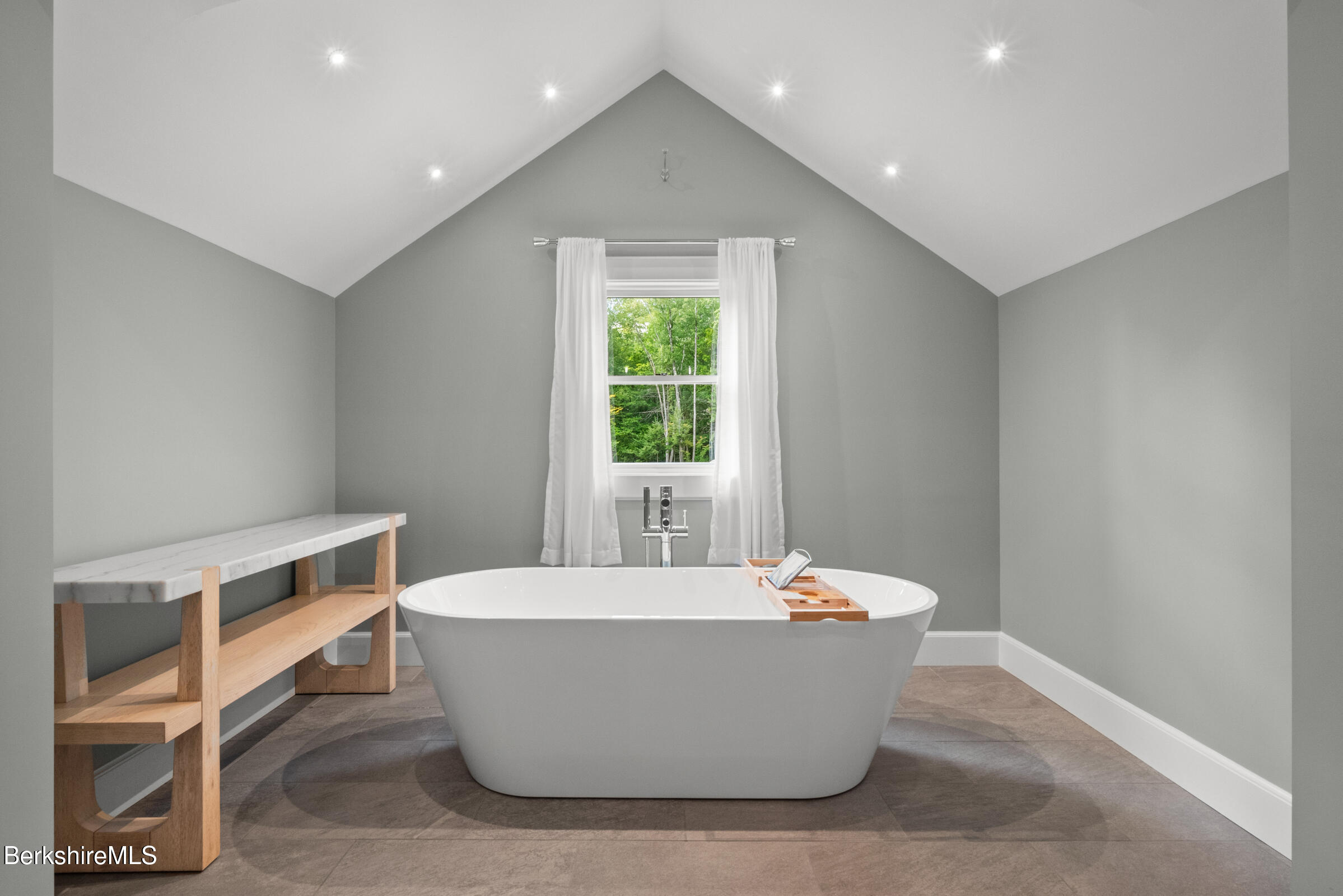 8 Webster Road Tyringham, MA 01264 - Photo 23 of 52 a white tub sitting in a room next to a window