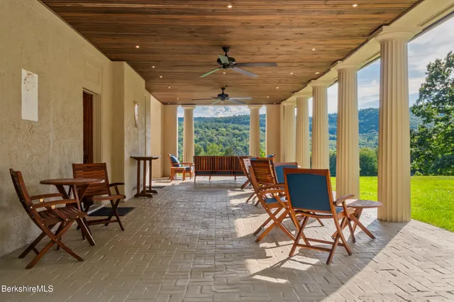 a living room filled with furniture and large windows