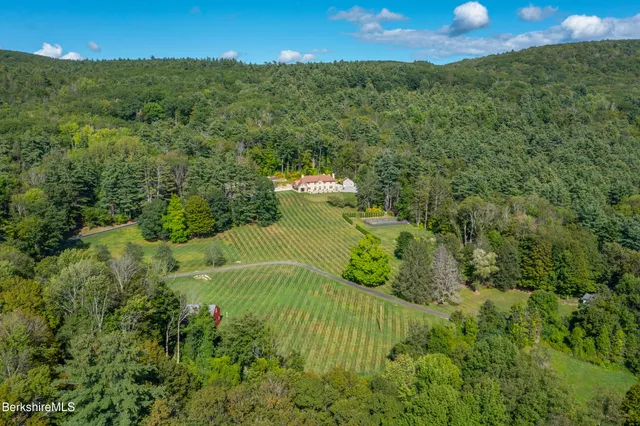 a view of house with garden and outdoor seating
