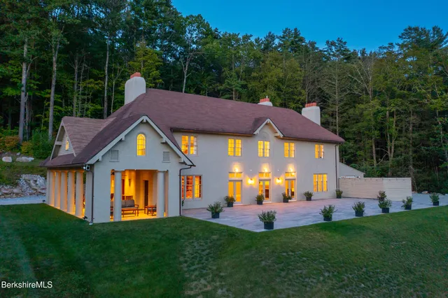 a aerial view of a house with a big yard and a large tree