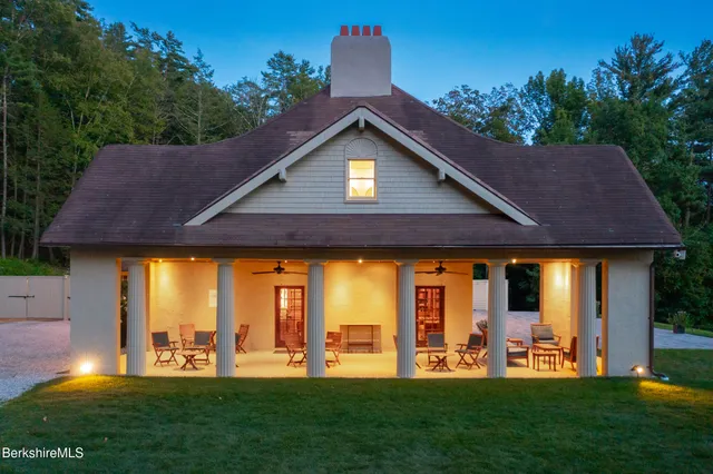 a view of a house with backyard porch and sitting area