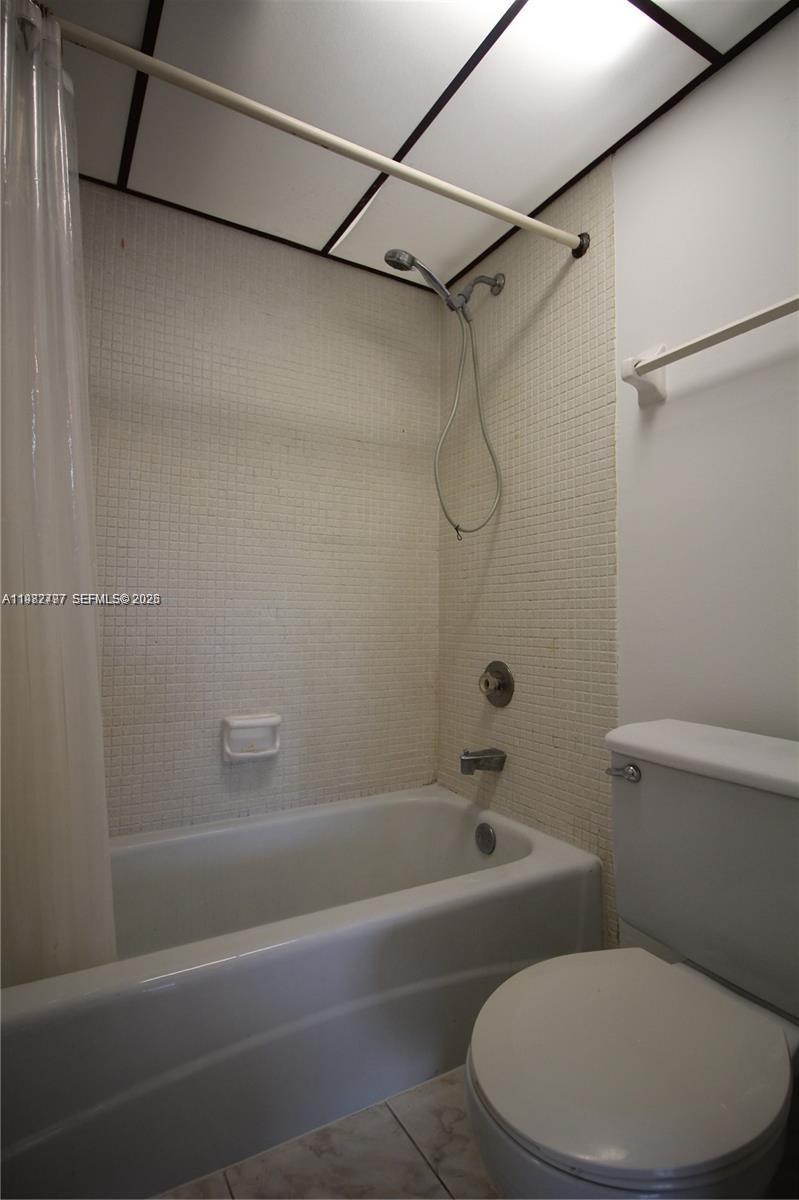 3680 Inverrary Drive, Unit 3D Lauderhill, FL 33319 - Photo 11 of 16 a white toilet and tub sitting next to a bathroom sink