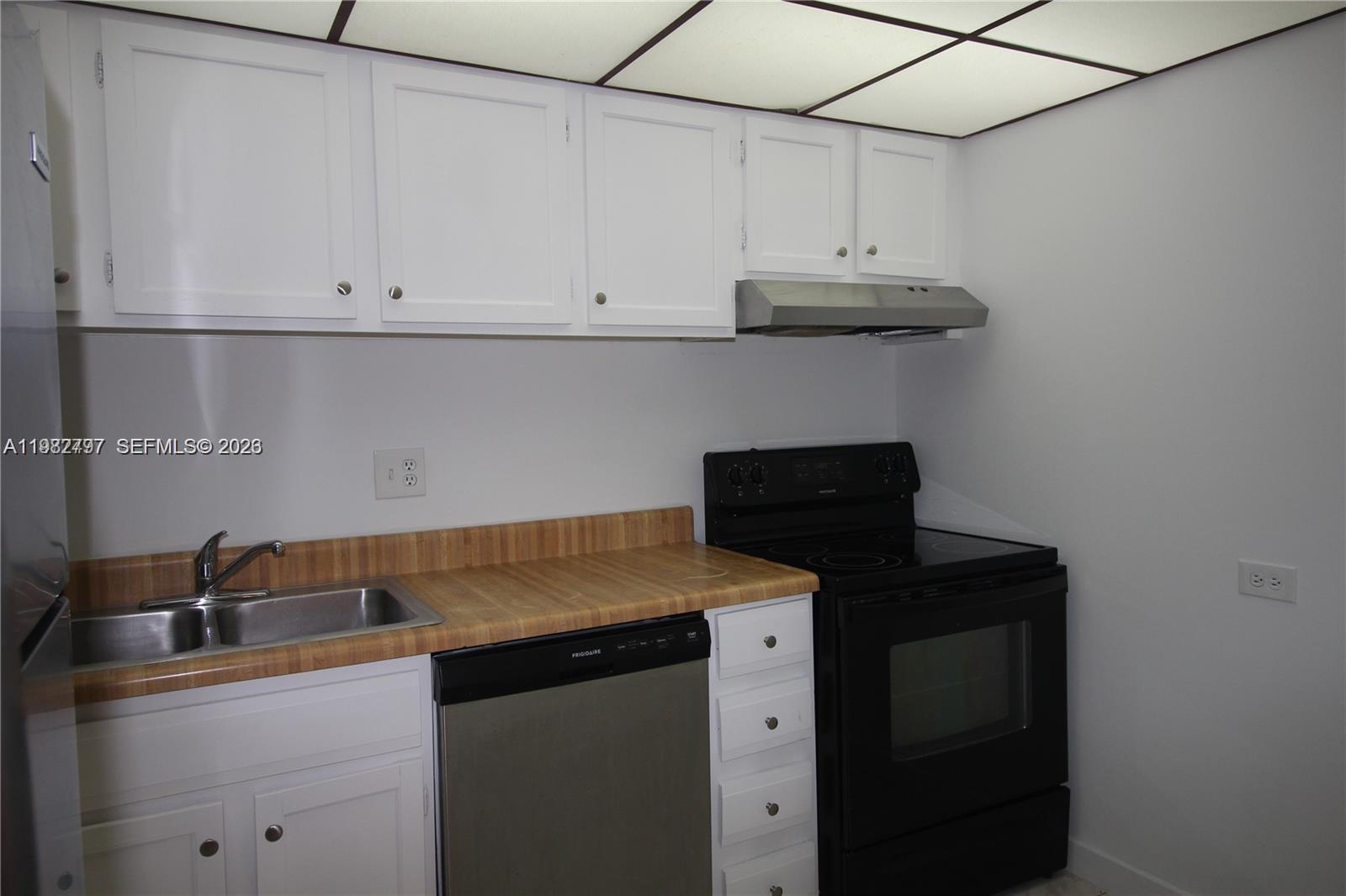 3680 Inverrary Drive, Unit 3D Lauderhill, FL 33319 - Photo 12 of 16 a kitchen with a sink and cabinets