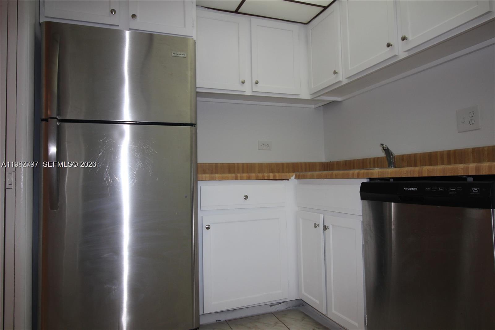 3680 Inverrary Drive, Unit 3D Lauderhill, FL 33319 - Photo 9 of 16 a view of a refrigerator in kitchen and an empty room
