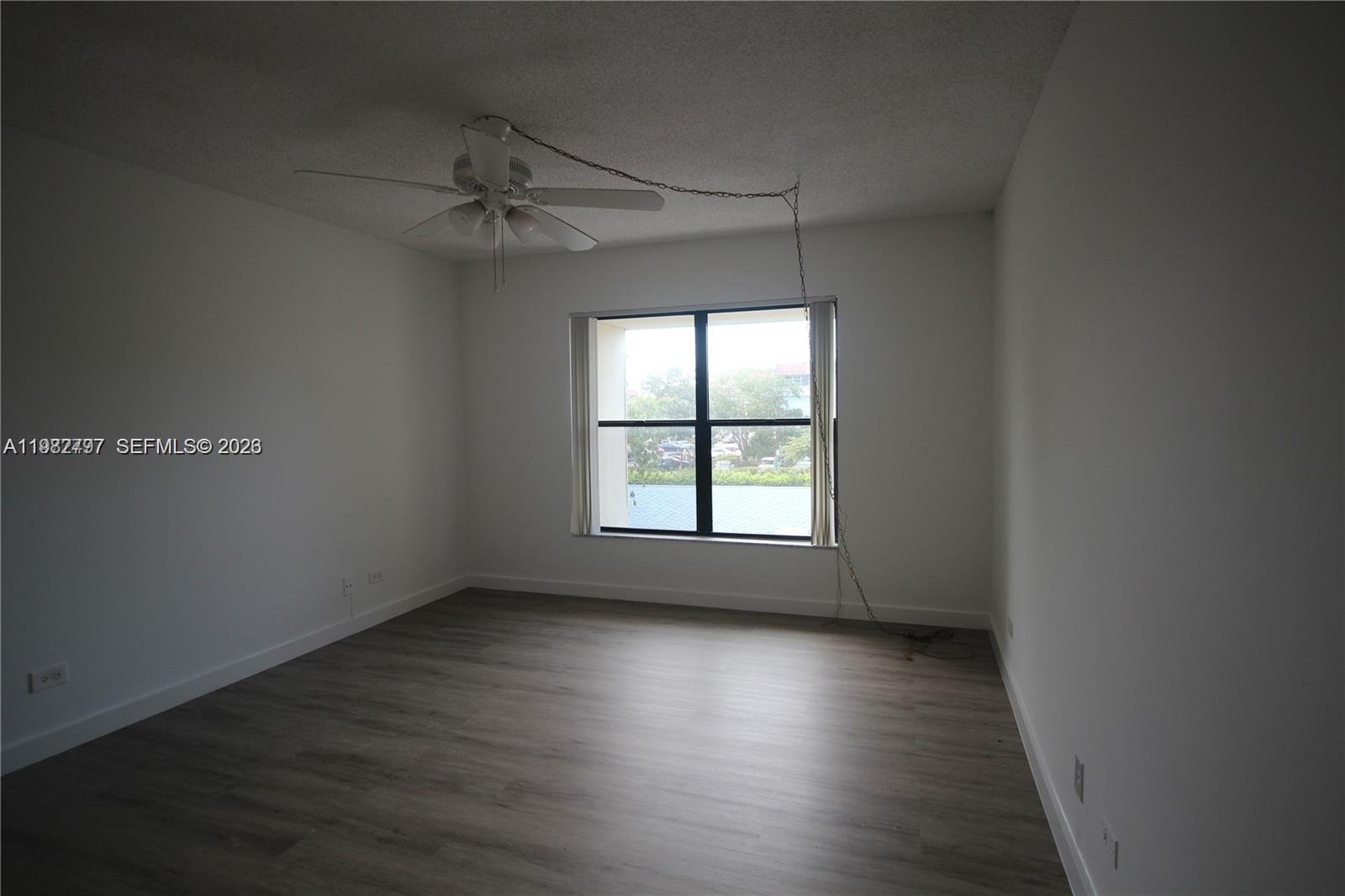 3680 Inverrary Drive, Unit 3D Lauderhill, FL 33319 - Photo 10 of 16 an empty room with wooden floor and windows