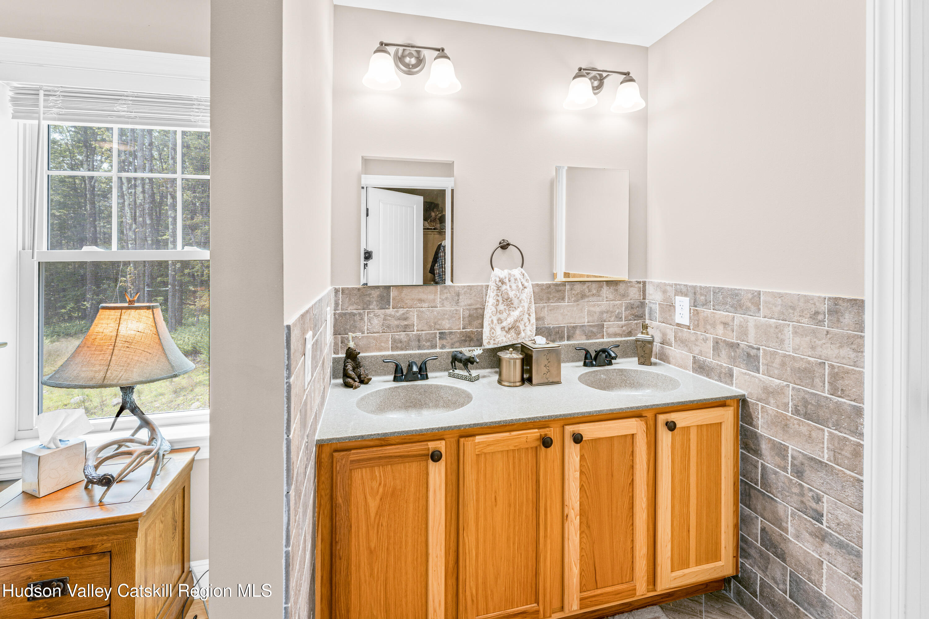 376 Aden Hill Road, Unit NEAR NEVERSINK RESERVOIR Neversink, NY 12768 - Photo 27 of 50 a bathroom with a granite countertop sink and a mirror