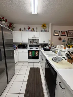 a kitchen with a sink a stove and cabinets