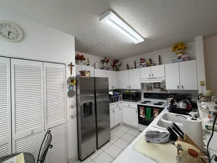 a kitchen with stainless steel appliances a refrigerator a sink and a stove