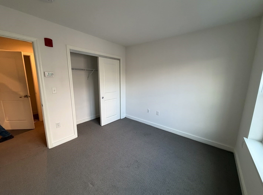 11 Alder Street, Unit 42B Waltham, MA 02453 - Photo 11 of 15 an empty room with windows