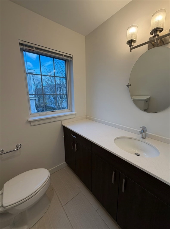 11 Alder Street, Unit 42B Waltham, MA 02453 - Photo 13 of 15 a bathroom with a sink vanity mirror and toilet