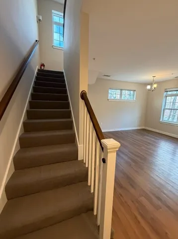 a view of entryway and hall with wooden floor