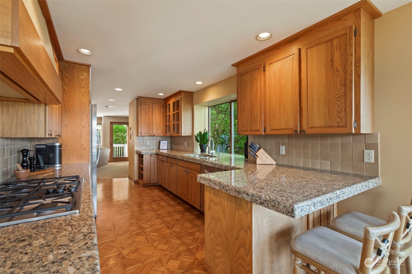 6244 East Mercer Way Mercer Island, WA 98040 - Photo 12 of 40 a kitchen with stainless steel appliances granite countertop a stove a sink and a microwave