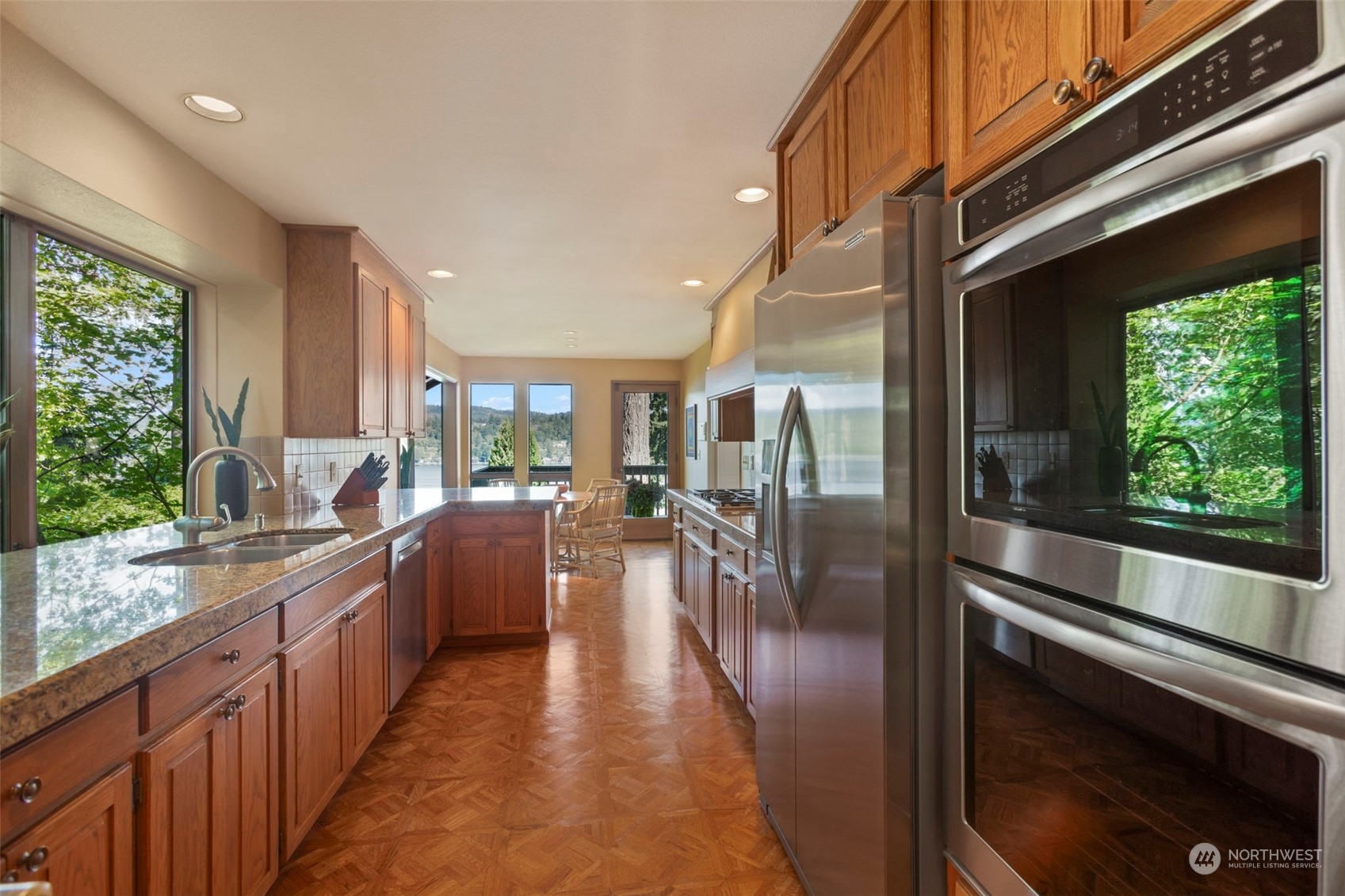6244 East Mercer Way Mercer Island, WA 98040 - Photo 14 of 40 a kitchen with stainless steel appliances granite countertop a refrigerator a stove and a wooden floors